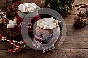 Christmas marshmallows and New Year decorations and sweet canes on a wooden background. Winter holidays, new year mood. Copy space