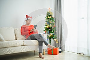 Christmas, x-mas, winter concept. Asian senior old woman using mobile phone to chat message smiling happy cheerful. Celebrates the