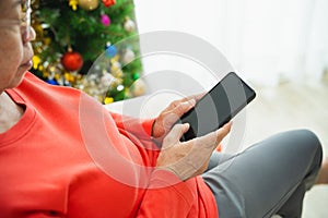 Christmas, x-mas, winter concept. Close up of hand, senior old woman using mobile phone to chat message happy cheerful. Celebrates