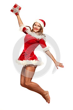 Christmas, x-mas, winter, concept - smiling woman in santa helper hat with gift box, happiness jump for joy isolated on