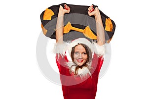 Christmas, x-mas, winter, happiness concept - Bodybuilding. Strong fit woman exercising with SANDBAG in santa helper hat