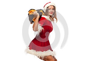 Christmas, x-mas, winter, happiness concept - Bodybuilding. Strong fit woman exercising with SANDBAG in santa helper hat