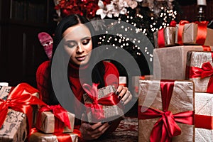 Christmas, x-mas, winter, happiness concept - smiling woman with many gift boxes with christmas tree