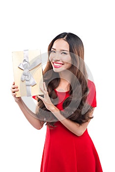 Christmas, x-mas, winter, happiness concept - smiling woman in red dress with gift box