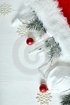 Christmas medical coronavirus flat lay, protective face mask, pills, antiseptics, decoration on white background