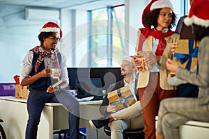 .Christmas meeting.People in santa hat at Xmas party at office