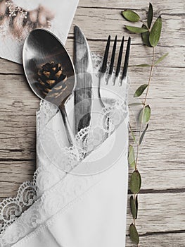 Christmas menu concept . Flat lay with Xmas decorations and cone, silver fork knife spoon set with napkin. Copy space