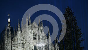 Christmas in Milan, Italy. The Duomo cathedral facade and a giant Christmas tree