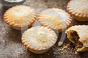 Christmas Mince pies with icing sugar .