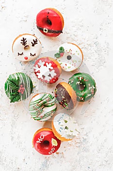 Christmas mini donuts with sprinkles on white festive background