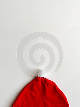 Christmas minimal composition. Children's Santa Claus hat on a white background. Christmas, New Year, winter concept.
