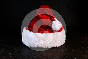 Christmas minimal concept with Santa`s red hat .