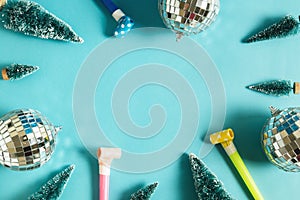Christmas minimal festive background with disco ball, toy tree, air whistles. Abstract christmas background shiny blue