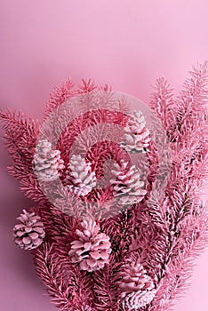 christmas minimalist composition of pink-blue paint of spruce branches and cones