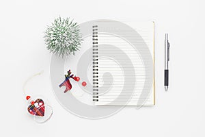 Christmas mockup background with blank space notebook, Christmas ornament decorations on white table. Space for text. Top view.