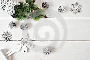 Christmas mockup on a white wooden background with snowflakes, a deer and a Christmas tree. Flat lay, top view