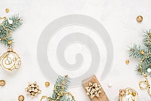 Christmas mood border of gift, green and gold decorations on white background.