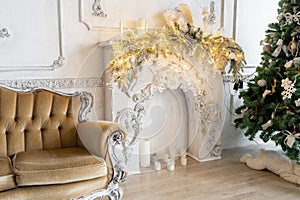 Christmas morning in classic apartments with a white fireplace, decorated tree, sofa, large windows and chandelier.