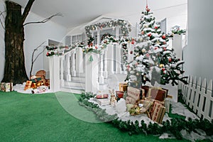 Christmas morning. classic luxury apartments with a white fireplace, decorated tree, bright sofa, large windows