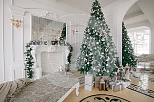 Christmas morning. classic luxury apartments with a white fireplace, decorated tree, bright sofa, large windows