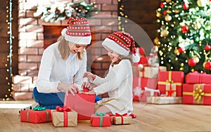 Christmas morning. family mother and daughter unpack, open gift