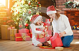 Christmas morning. family mother and daughter unpack, open gift