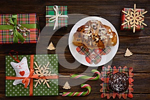 Christmas morning table with croissant and gifts. Top view