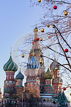 Christmas Moscow city decoration. Trees with gold and red balls on St Basils cathedral background