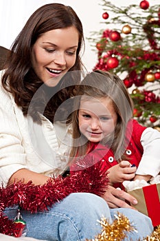 Christmas:Mother with child opening present