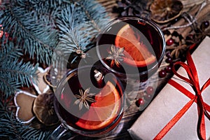 Christmas mulled red wine with and ingredients on a wooden brown table. Traditional hot drink at Christmas holiday