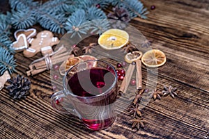 Christmas mulled red wine with and ingredients on a wooden brown table. Traditional hot drink at Christmas holiday