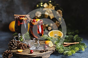 Christmas mulled red wine with spices, cranberry and fruits. Traditional Christmas hot drink. Christmas drink background