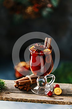 Christmas mulled red wine with spices, cranberry and fruits. Traditional Christmas hot drink. Christmas drink background