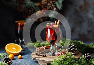 Christmas mulled red wine with spices, cranberry and fruits. Traditional Christmas hot drink. Christmas drink background