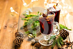 Christmas mulled red wine with spices and oranges on a wooden rustic table. Traditional hot drink at Christmas photo