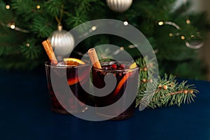 Christmas mulled wine with cinnamon stick, orange, anise and cloves on a blue background. Winter holidays