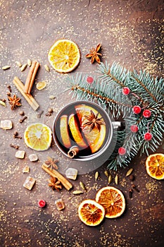 Christmas mulled wine or gluhwein with spices and orange slices on rustic table top view. Traditional drink on winter holiday.