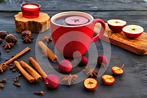 Christmas mulled wine with spices and apple in red mug