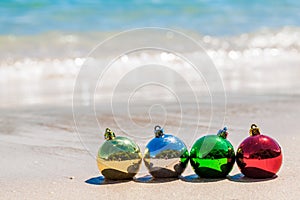 Christmas multicolored decoration balls on seashore
