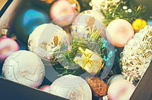 Christmas multicolored toys, textured balls lie in an open box, effect of the instagram