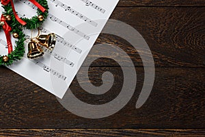 Christmas music note paper with Christmas wreath on wo