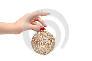 Christmas nail design. Female hand with red xmas manicure. Female hold golden new year toy orb. Happy New Year