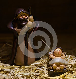 Christmas nativity scene of baby Jesus in the manger. Infant Jesus  and Joseph colored figurines