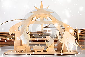 Christmas Nativity Scene of baby Jesus in the manger with Mary and Joseph in silhouette surrounded by the animals