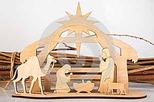 Christmas Nativity Scene of baby Jesus in the manger with Mary and Joseph in silhouette surrounded by the animals