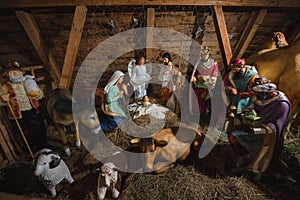 Christmas nativity scene with baby Jesus, Mary, Joseph and three kings in barn