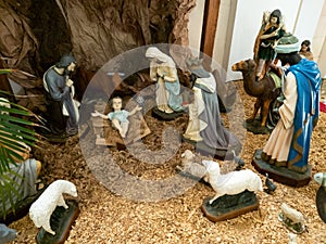 Christmas nativity scene with figurines including Jesus, Mary, Joseph, sheep and wizards