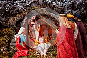 Christmas nativity scene with Holy Family in the hut and the three wise men.