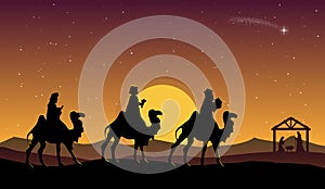 Christmas Nativity Scene: Three Wise Men go to the manger in the desert at dusk.