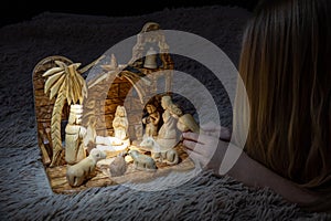 Christmas nativity scene with three Wise Men presenting gifts to baby Jesus, girl play